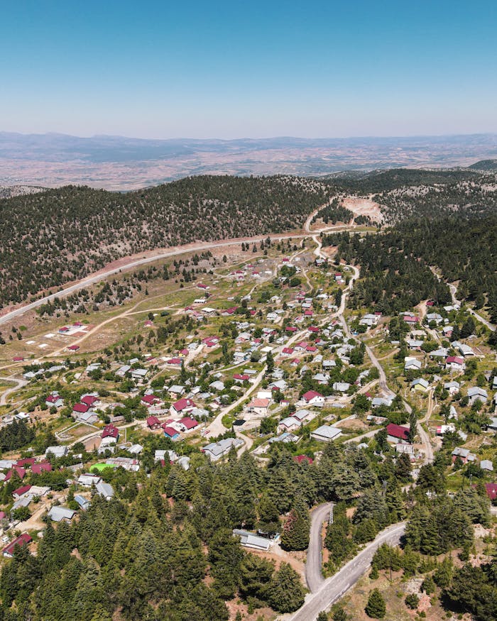 hero-img-02 Drone shot of a picturesque rural village surrounded by forests in Konya, Turkey.