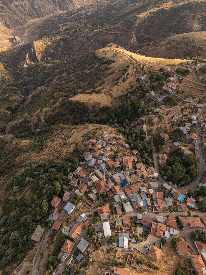 gallery-3 Scenic aerial shot of a picturesque rural village surrounded by mountainous terrain.