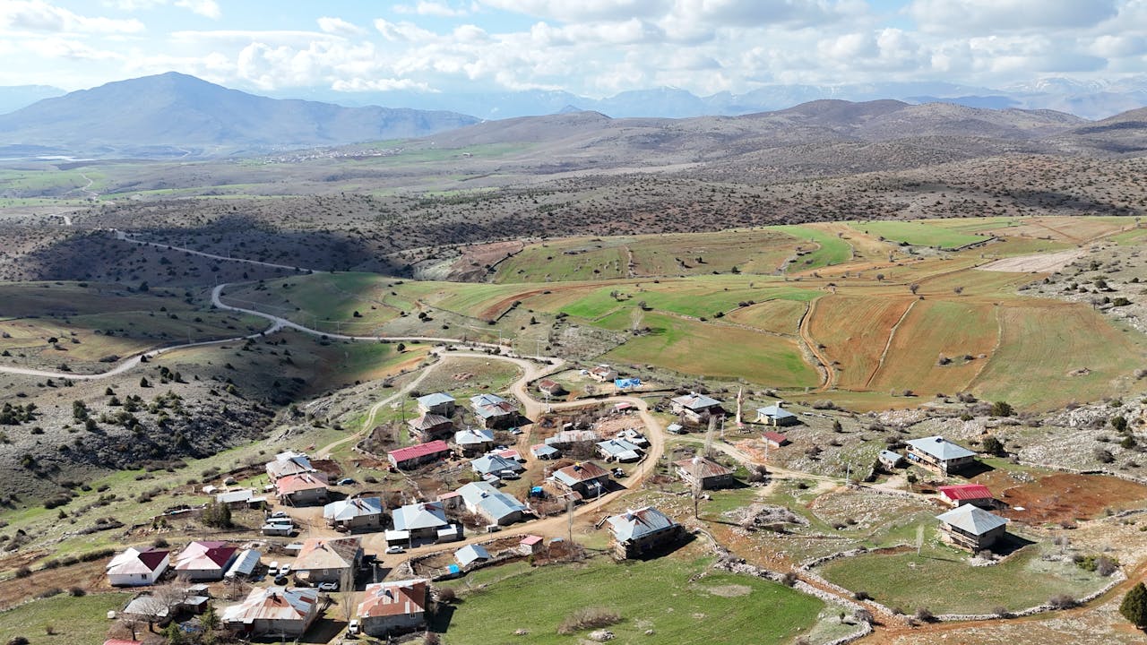 services-img Explore the rural beauty and winding roads of Adana, Türkiye, captured in a vibrant aerial photograph.