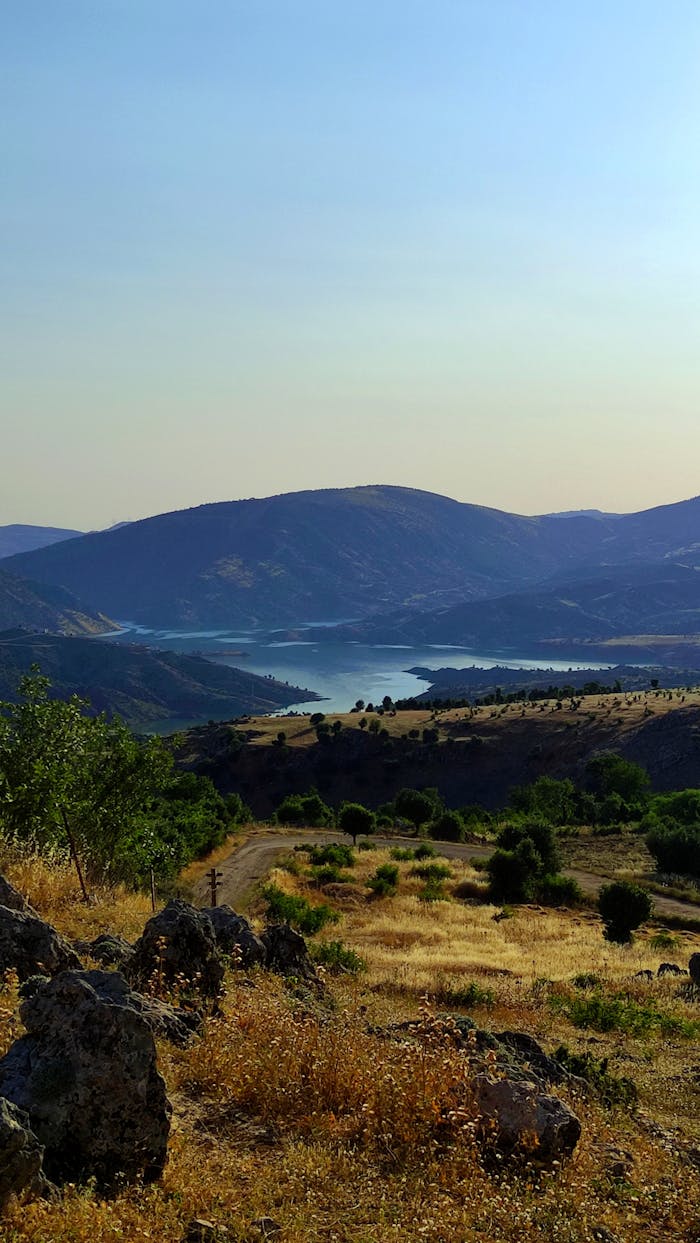 gallery-2 Breathtaking vista of Åžirvans landscape with lake and mountains under a clear sky.